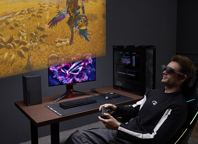 Мужчина отдыхает на диване и играет в Monster Hunter в игровых AR-очках ROG R1 на портативной консоли ROG Xbox Ally